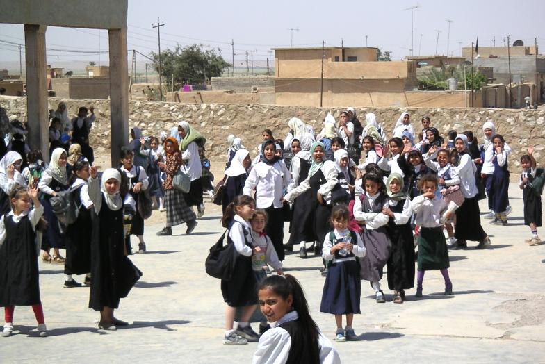 Photograph of school yard full of Iraqi children. Photograph by an American soldier of C Co, 1/252 Army Reserve Battalion. 